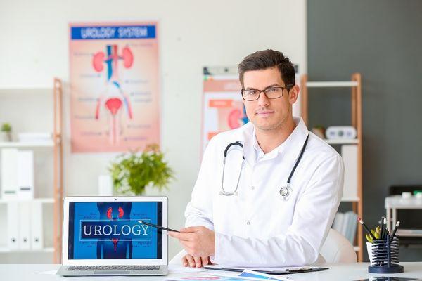 A urologist pointing at a laptop